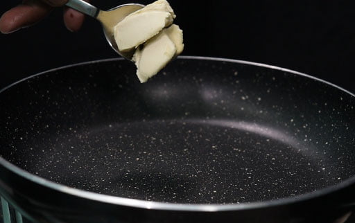 pour-butter-with-spoon-in-pan