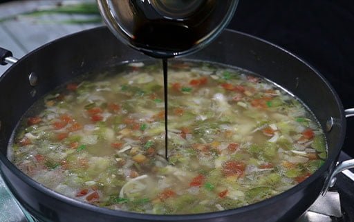 pour-soya-sauce-in-hot-n-sour-chicken-soup