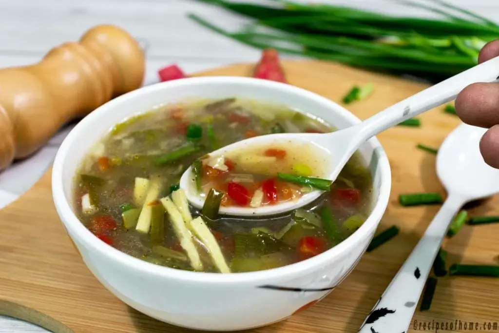pick-healthy-vegetable-soup-by-spoon-in-white-bowl