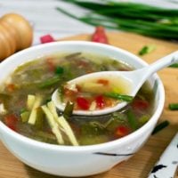 pick-healthy-vegetable-soup-by-spoon-in-white-bowl