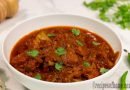 spicy-chicken-masala-recipe-serve-on-white-serving-bowl-sprinkling-chopped-coriander-leaves