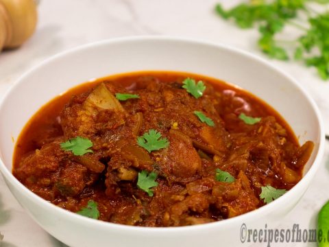 spicy-chicken-masala-recipe-serve-on-white-serving-bowl-sprinkling-chopped-coriander-leaves