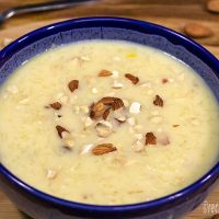 rice-kheer-recipe-sprinkle-with-chopped-dried-fruits-in-blue-ceramics-bowl