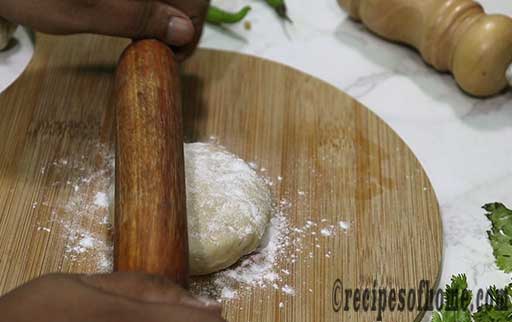 dust flour and spread dough using rolling pin