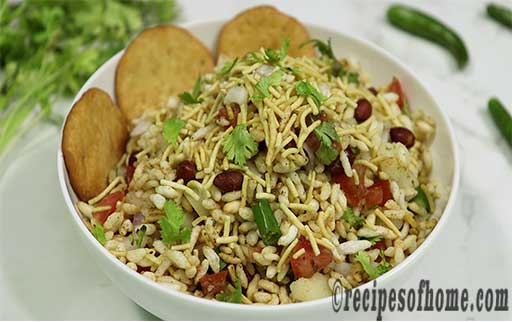 garnish bhel puri with papri and fresh coriander leaves