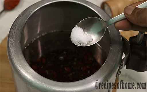 pour soaked dal in pressure cooker additionally sprinkle salt