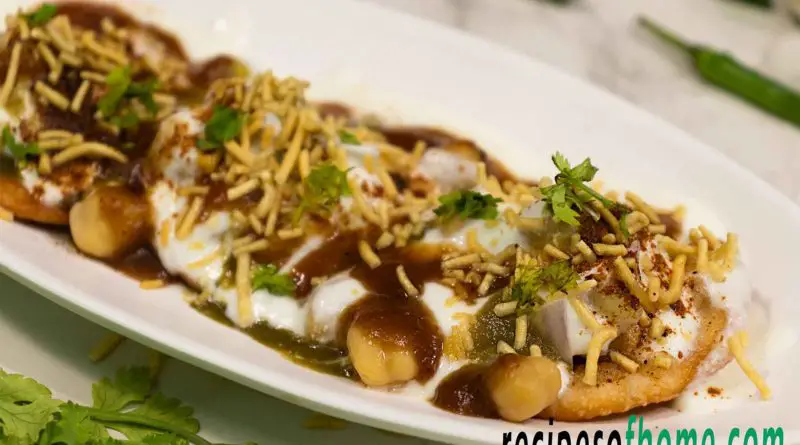 dahi papdi chaat recipe serving on white plate garnish with sev and chopped coriander leaves