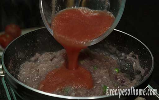 pour tomato puree in pan