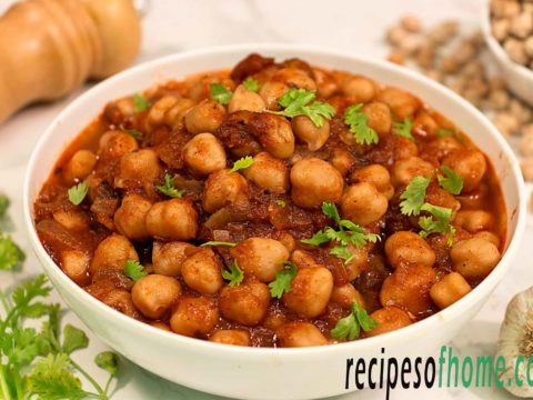 chana masala recipe serve on white bowl garnish with chopped coriander leaves