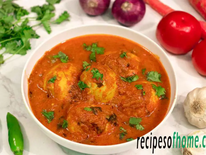 spicy egg curry recipe serve on white bowl,garnsih with freshly chopped coriander leaves