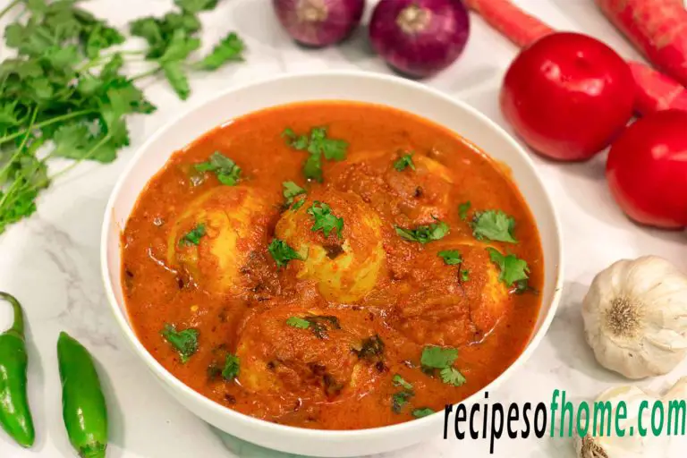 spicy egg curry recipe serve on white bowl,garnsih with freshly chopped coriander leaves
