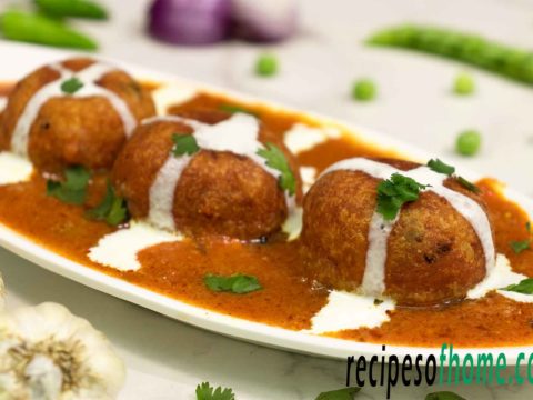 malai kofta recipe serve on white plate garnish with cream and freshly chopped coriander leaves