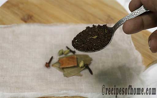 place green cardamom,clove,cinnamon,bay leaf,a few tablespoon of tea leaves in a white cotton cloth