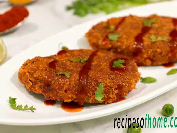 crispy veg cutlet recipe serve on white plate garnish with tomato ketchup and chopped coriander leaves