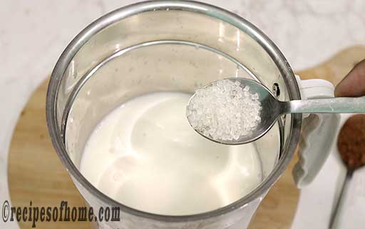 pour chilled milk in blender and add sugar