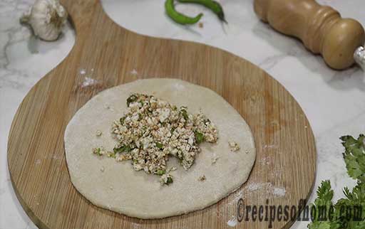 pour paneer stuffing mixture inside dough