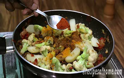 sprinkle turmeric powder, coriander powder, garam masala powder, red chili powder