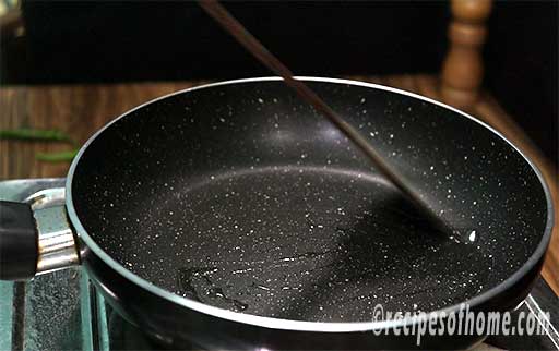 pour oil in a pan and spread it with a spatula