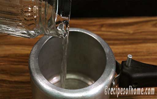 pour water in a pressure cooker