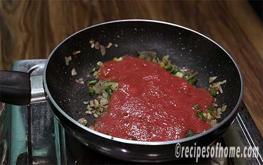 pour tomato puree and cook till raw smell disappear