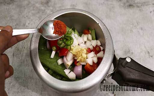 add green leaves , veggies , salt ,red chili powder in preessure cooker