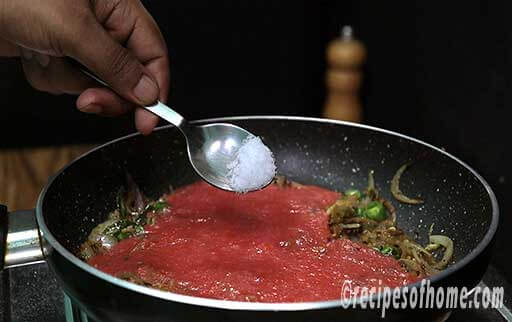 pour tomato puree and pinch of salt