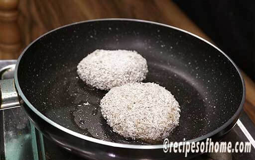 fry coated chicken patties in a pan