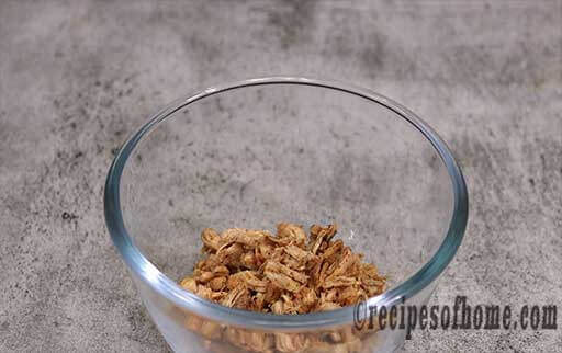 pour cooked chicken in a large mixing bowl