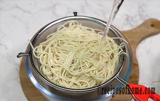 drain cooked noodles in strainer with cold water then apply water
