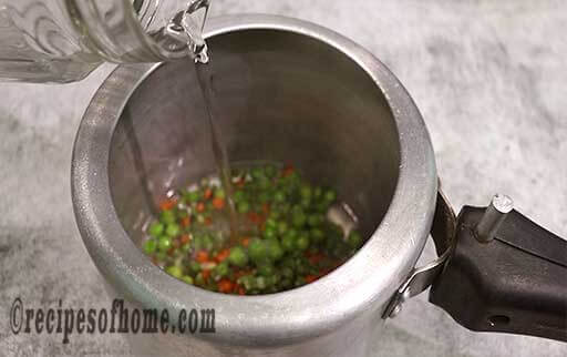 pour veggies and water in pressure cooker