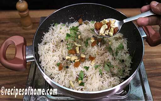 garnish with roasted cashews , raisins , coriander leaves , black pepper powder