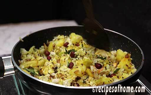 gently stir kanda batata poha in medium to low flame