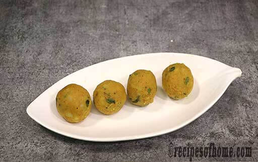 keep small circular batata vada mixture on a serving plate