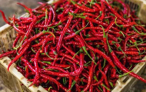 Remove seeds from chilli peppers to reduce heat